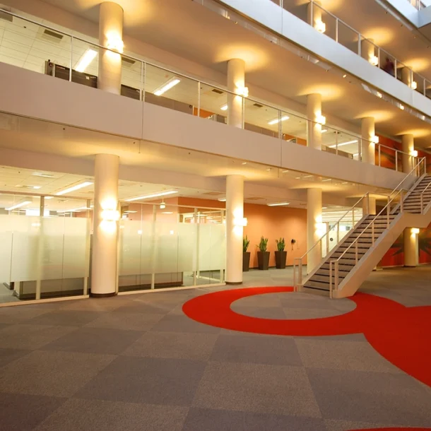 interior of a modern office building or a corporate lobby, possibly featuring multiple floors and open workspaces